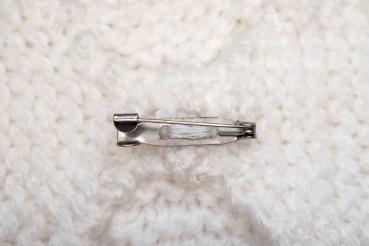 Hand knitted brooch in white with red pearl